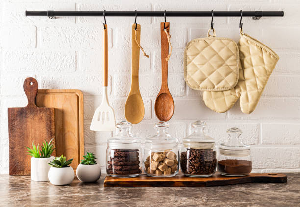 istock Beautiful kitchen background with various glass jars for bulk products, cutting boards, indoor cacti in pots. modern kitchen decor. 1448503021