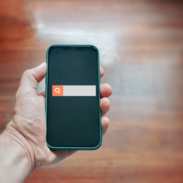 istock hand holding a smart phone  searching on internet 1448503120