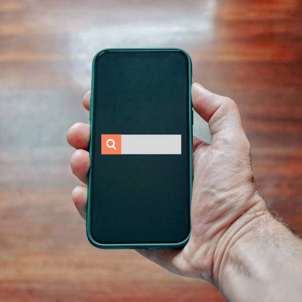 istock hand holding a smart phone  searching on internet 1448503124
