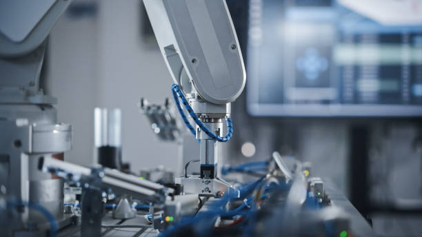 istock Industry 4.0 Modern Factory: Programmed Robot Arm Moving at Different Sides. Production Line Machine at Empty room.No people, Close Up View. Automated Robotics Concept 1448503425