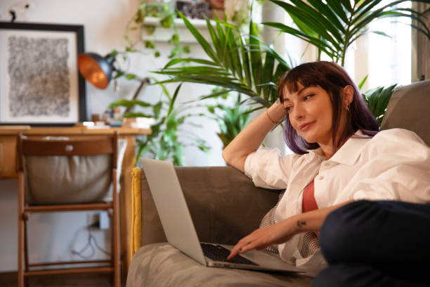 istock Woman at home use laptop on the sofa 1448503509