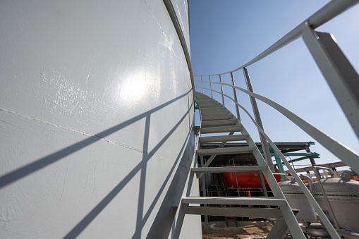 Metal stairs on a fuel storage tank at a chemical plant