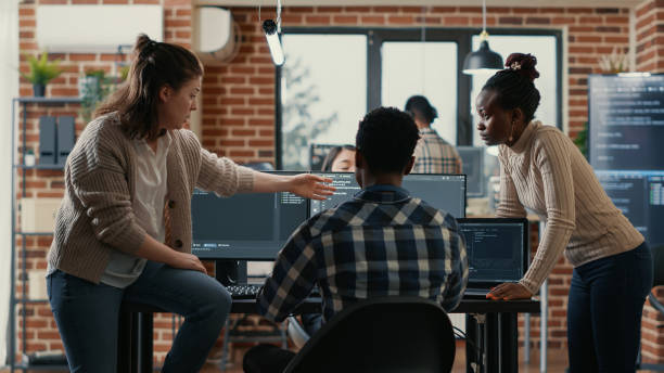 istock System engineer sitting on desk discussing with mixed team of coders about ai innovation 1448504535