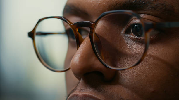 istock Closeup portrait of african american database developer with glasses working focused looking at computer screen 1448505715