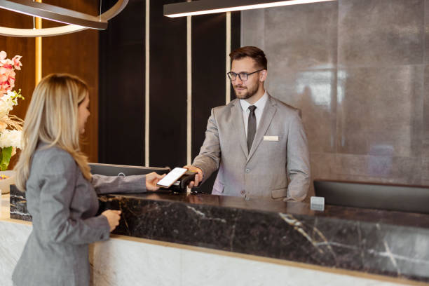 istock Hotel Receptionist taking Contactless Payment 1448505908
