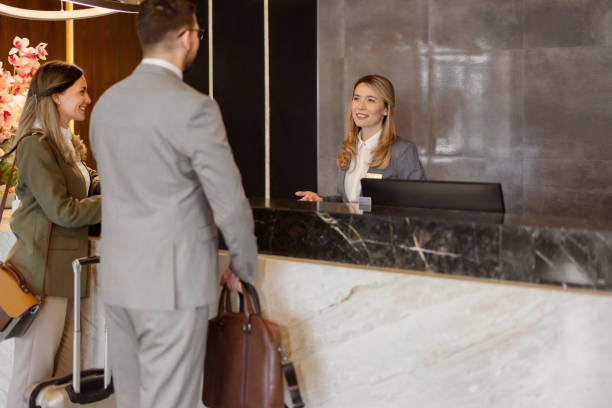 istock Receptionist at front office talking with guest in the hotel 1448506134