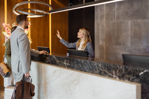 istock Receptionist at front office talking with guest in the hotel 1448506191