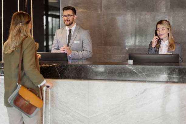 istock Male hotel receptionist assisting female guest 1448506309