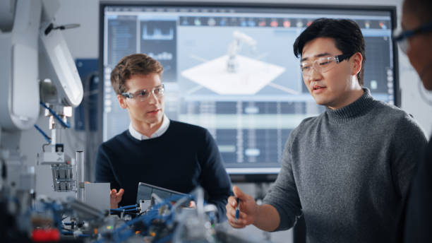 istock Male Student Gesturing and Holding Tablet While Working on Project with Classmate and Black Teacher. People Analysing Modern Technologies During Lesson. Science and Developing Concept. 1448507544