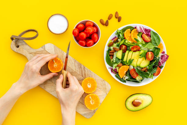 istock Hands cooking vegetarian salad with avocado and tomatoes 1448508117