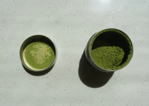Matcha green tea powder in a tin