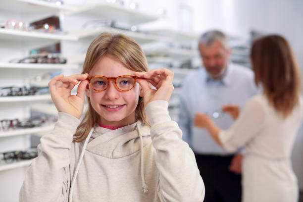 istock Girl trying on new eyeglasses 1448510871