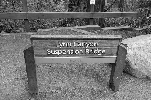 North Vancouver, BC, Canada- October 10, 2022: Black and white Lynn Canyon suspension bridge sign at Lynn Canyon municipal park located in the District of North Vancouver, British Columbia