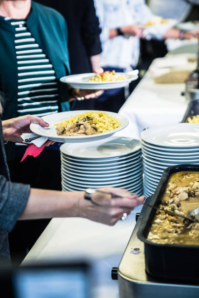 istock people take food on the plate at the buffet 1448512417