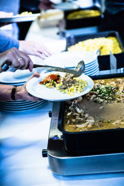istock people take food on the plate at the buffet 1448512428