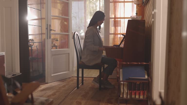 Beautiful woman playing piano