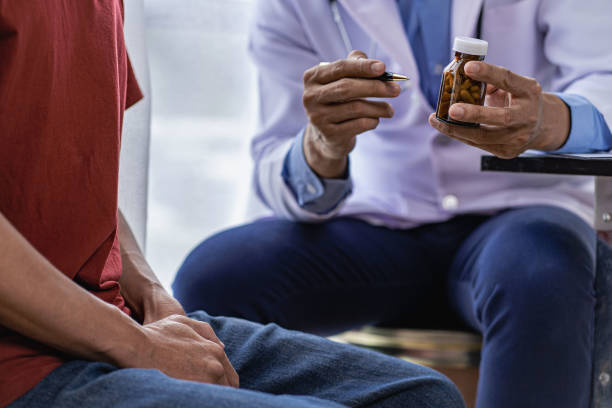 istock Doctor consulting with young man about venereal disease including sexual dysfunction and prostate cancer concept of men's health problems 1448513177