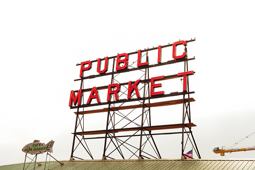 Seattle, Washington, USA- October 4, 2022: Neon sign of Seattle's famous public market, Pike Place Market against a foggy sky