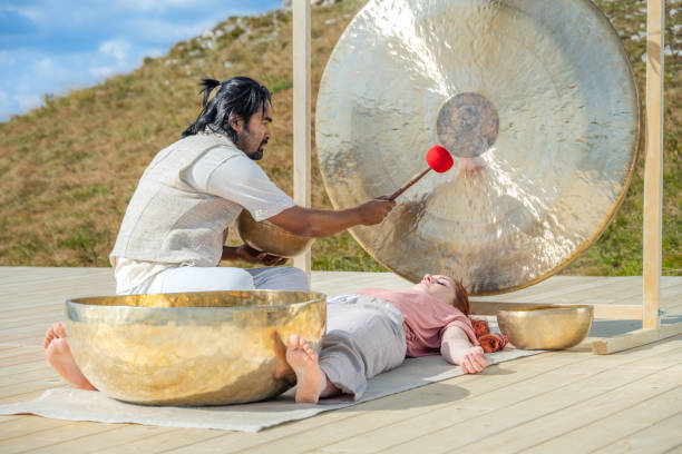 istock Man playing gong for sound therapy 1448513723