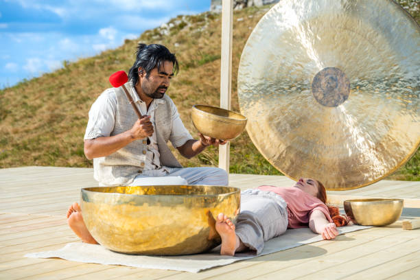 istock Man playing rin gong for sound therapy 1448513726