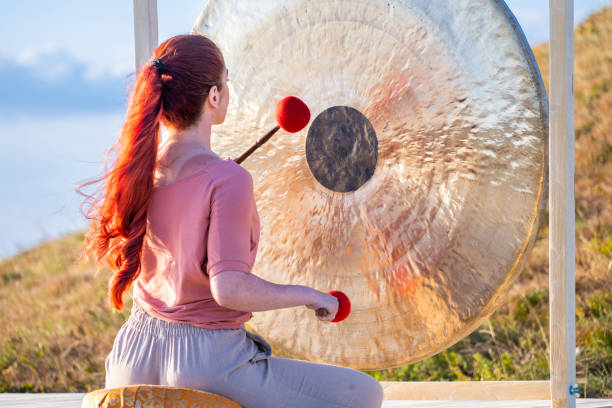 istock Woman playing gong for sound therapy 1448513807