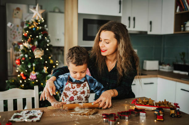 istock Mother and son making gingerbread cookies for Christmas. 1448515106