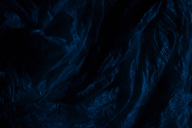 istock Dark plastic wrap background. Crumpled wrinkled plastic cellophane. Texture overlay effect template 1448515476