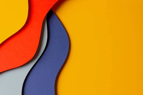 istock Abstract colored paper texture background. Minimal paper cut style composition with layers of geometric shapes and lines in red, yellow and blue colors. Top view 1448515790