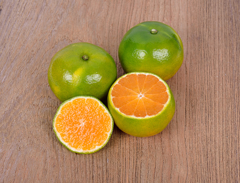 Fresh tangerines with high vitamin C content. isolated from the wooden background