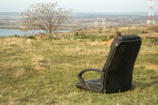 Abandoned chair in the field