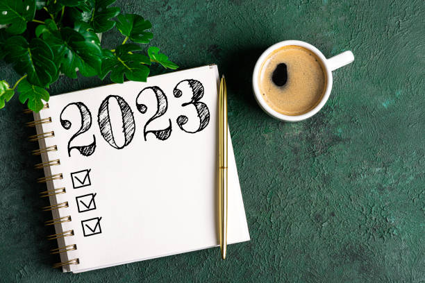 istock New year resolutions 2023 on desk. 2023 resolutions list with notebook, coffee cup on table. Goals, resolutions, plan, action, checklist concept. New Year 2023 template 1448518783