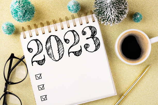 istock New year resolutions 2023 on desk. 2023 resolutions list with notebook, coffee cup, decorations on table. Goals, resolutions, plan, action concept. New Year 2023 template 1448519146