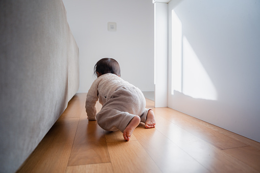Baby crawling by herself at home