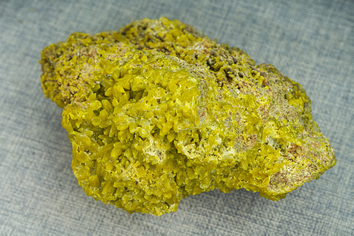 Close-up of naturally occurring rare yellow crystalline ore