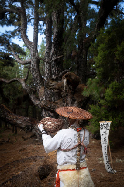 istock shugendo monk standing and praying in front of large pine tree 1448524064