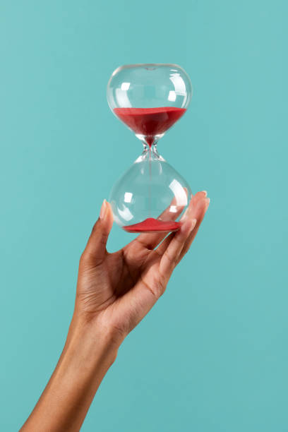 Black female hand with hourglass