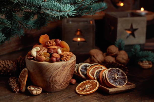 istock Dried fruits and assorted nuts on an old wooden table. 1448527763