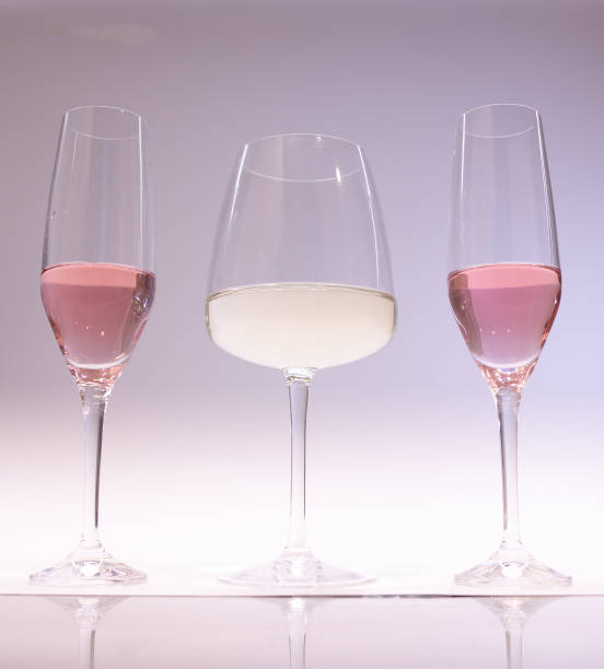 istock White and pink wine in glasses for tasting with friends. light background 1448528357