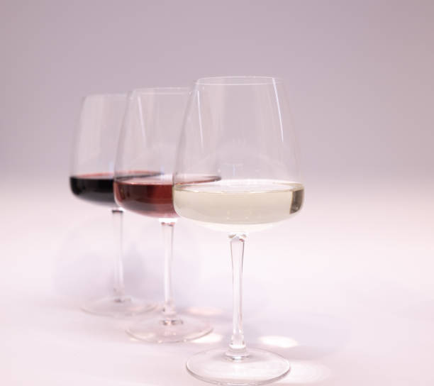 istock Red, white and rose wine glasses up. White background 1448528360