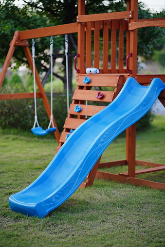 Kid children having fun with blue slide