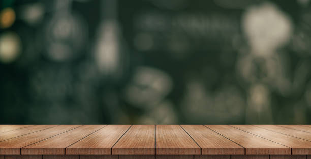 istock Empty wooden table top with lights bokeh on blur restaurant background. 1448530067