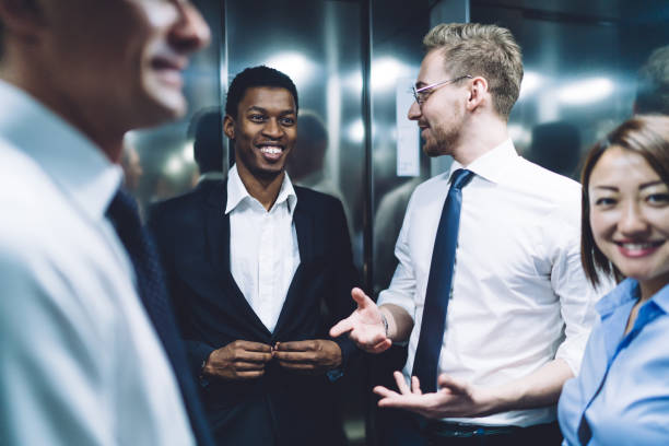 istock Diverse happy team of colleagues communicating in elevator 1448530247