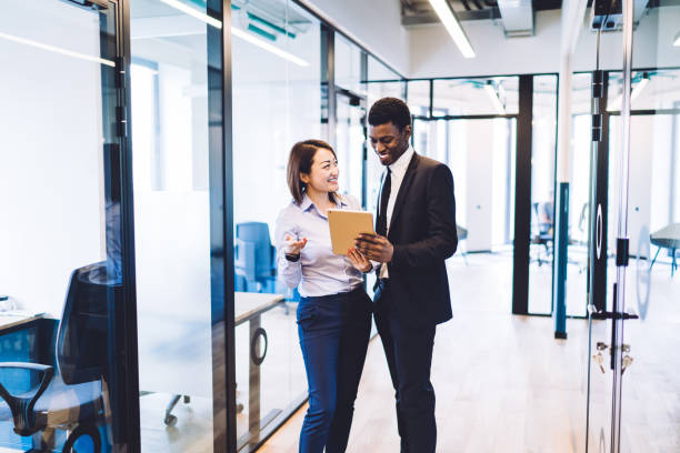 istock Businesspeople browsing tablet in office 1448530265