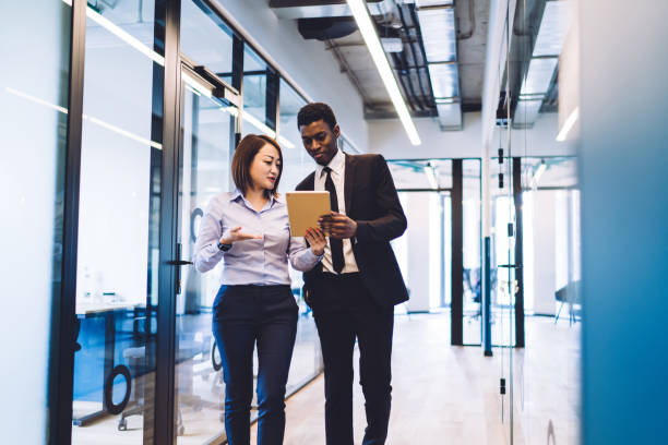 istock Diverse colleagues with tablet discussing business issue 1448530267