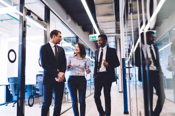 istock Successful business team talking in office corridor 1448530268