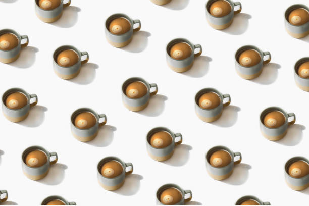istock Flat lay pattern of grey cups of coffee on white background 1448532623