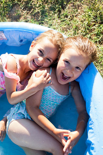 little girls having fun in a pool