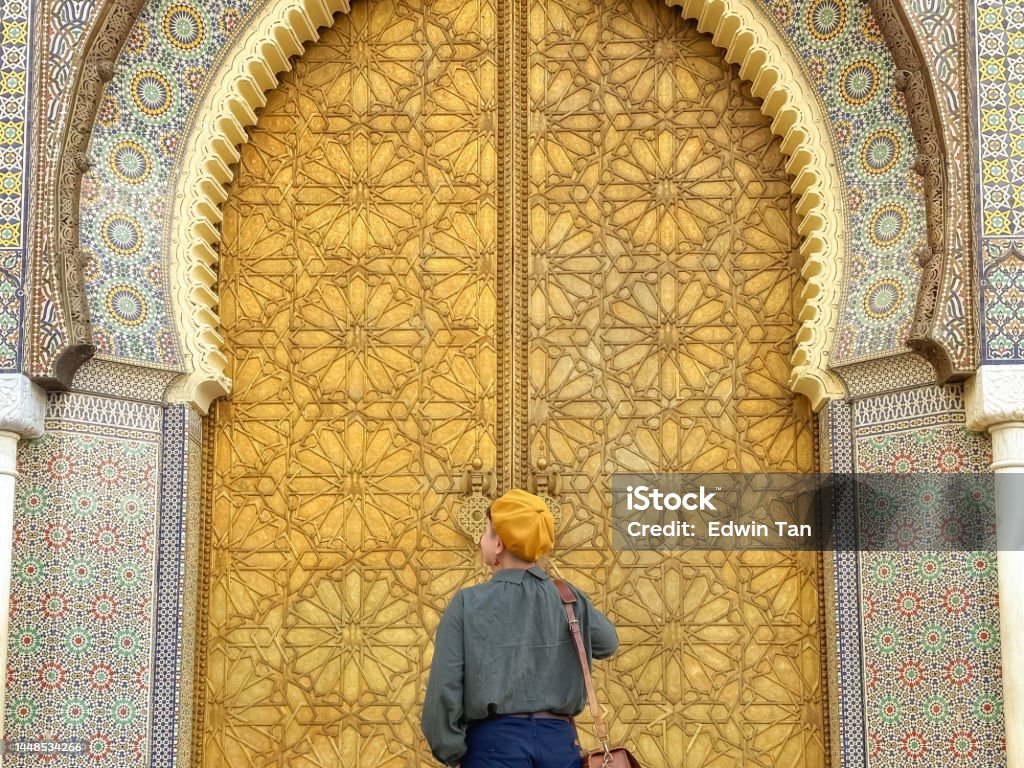 Asian Chinese female tourist looking at Royal palace entrance in Fes, Morocco. Admiration Stock Photo
