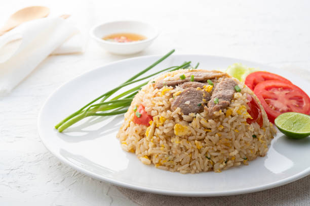 istock Close up Easy Pork Fried Rice with egg and tomato in white plate 1448534910