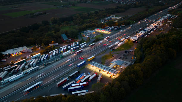 istock Highway and rest area at dusk - aerial view 1448537350